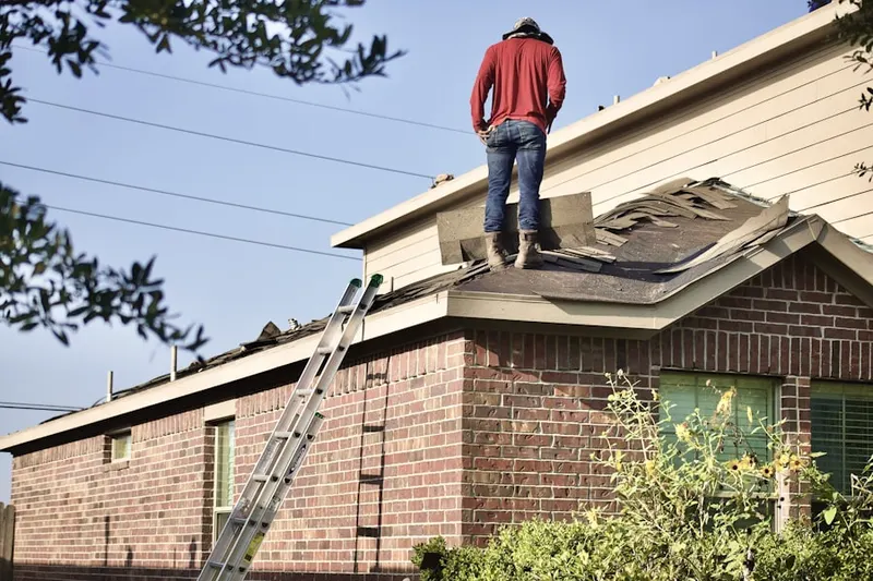 Professional roofer working on a residential roof in Humble